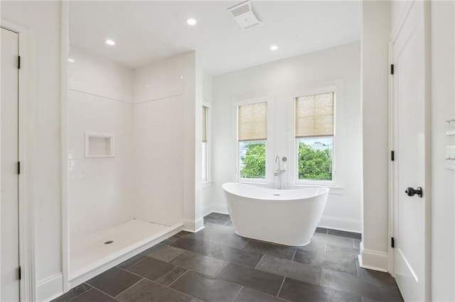 845 Pontalba St, New Orleans, LA 70124 - bathroom with a soaking tub, a walk in shower, recessed lighting, and stone finish flooring