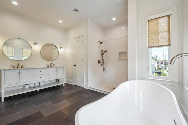 845 Pontalba St, New Orleans, LA 70124 - full bath with double vanity, a freestanding bath, a walk in shower, and recessed lighting