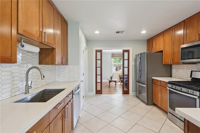 528 Carrollton Ave, Metairie, LA 70005 - kitchen featuring appliances with stainless steel finishes, light countertops, brown cabinetry, recessed lighting, and tasteful backsplash
