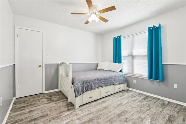304 Jeffer Dr, Waggaman, LA 70094 - bedroom with wood finished floors, a textured ceiling, and ceiling fan