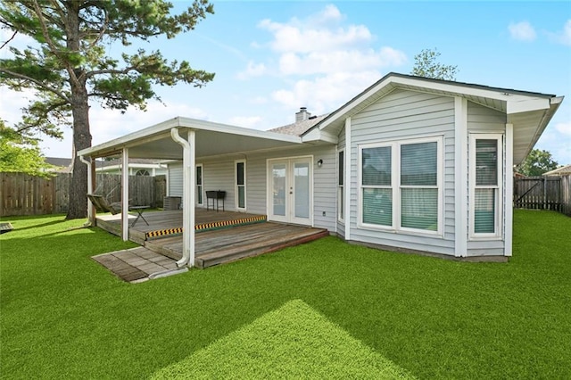 304 Jeffer Dr, Waggaman, LA 70094 - back of property with french doors, a fenced backyard, a deck, and a chimney