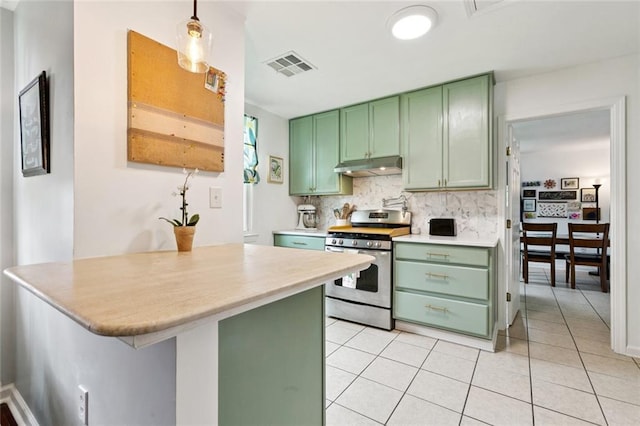 541 Gelpi Ave, Jefferson, LA 70121 - kitchen with green cabinets, gas stove, under cabinet range hood, and light countertops