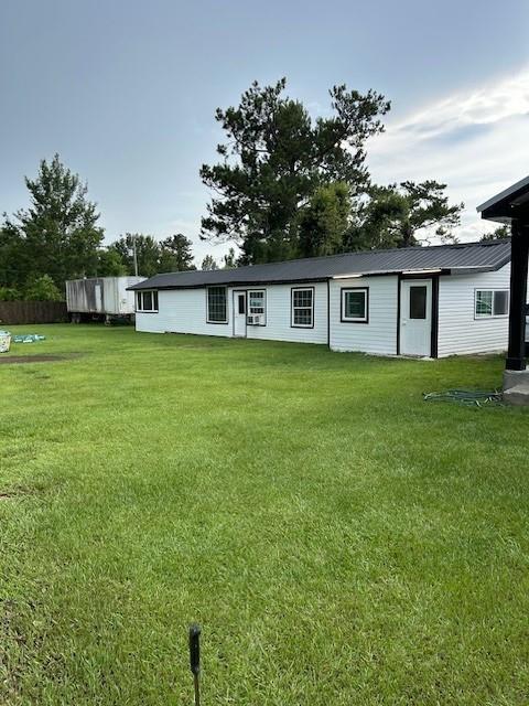 2310 Carlie St, Franklinton, LA 70438 - rear view of house featuring a lawn