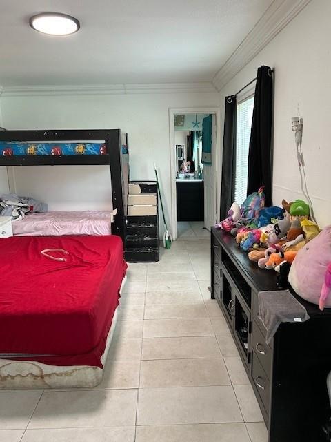 2310 Carlie St, Franklinton, LA 70438 - bedroom featuring ornamental molding and light tile patterned floors