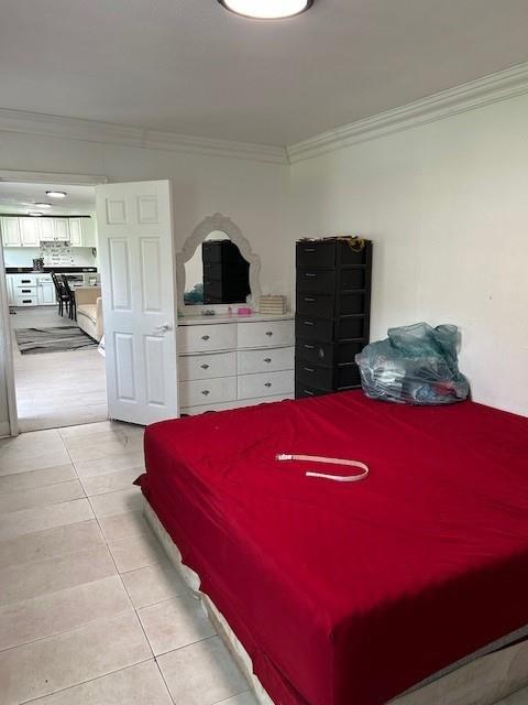 2310 Carlie St, Franklinton, LA 70438 - bedroom with ornamental molding and light tile patterned flooring