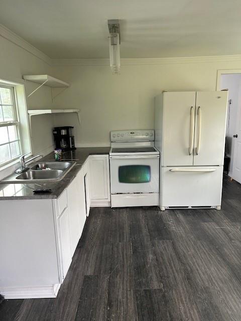 2310 Carlie St, Franklinton, LA 70438 - kitchen featuring white appliances, dark wood-style flooring, white cabinets, crown molding, and open shelves