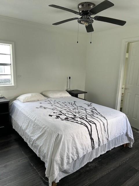2310 Carlie St, Franklinton, LA 70438 - bedroom featuring dark wood-style flooring, crown molding, and ceiling fan
