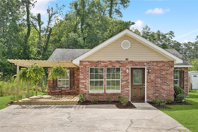 128 Marilyn Dr, Slidell, LA 70461 - ranch-style house with brick siding, a front lawn, and a patio