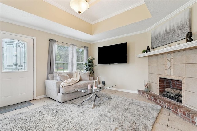 128 Marilyn Dr, Slidell, LA 70461 - living room featuring tile patterned floors, ornamental molding, a fireplace with raised hearth, and a raised ceiling