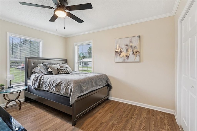 128 Marilyn Dr, Slidell, LA 70461 - bedroom with wood finished floors, ornamental molding, a ceiling fan, and a textured ceiling