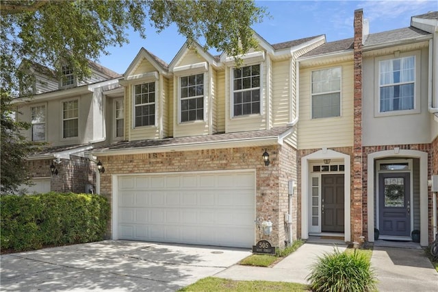 505 Rose St, Metairie, LA 70005 - view of property with a garage, driveway, a chimney, and brick siding
