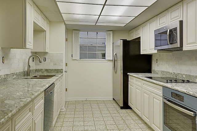 4433-35 Carondelet St, New Orleans, LA 70115 - kitchen featuring stainless steel appliances, decorative backsplash, and light stone countertops