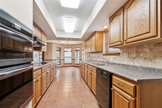 632 Brouilly Dr, Kenner, LA 70065 - kitchen with dishwasher, stainless steel double oven, a tray ceiling, light tile patterned flooring, and under cabinet range hood