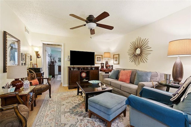 2704 Whitney Pl Unit 922, Metairie, LA 70002 - living area featuring light wood finished floors, ceiling fan, and a textured ceiling