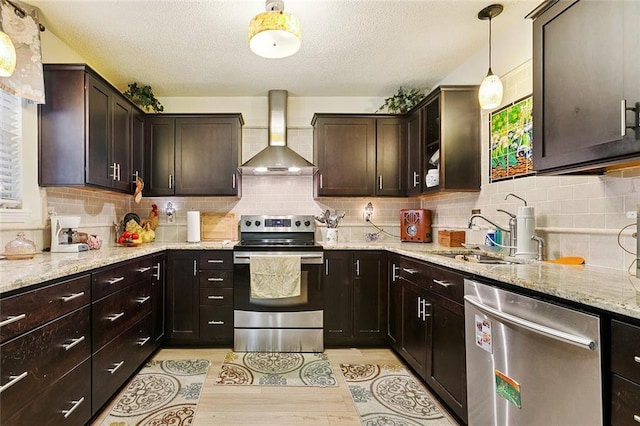 2704 Whitney Pl Unit 922, Metairie, LA 70002 - kitchen featuring appliances with stainless steel finishes, wall chimney exhaust hood, dark brown cabinets, light wood-style floors, and a textured ceiling