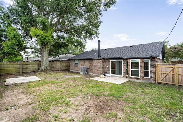 1408 N Sugar Ridge Rd, La Place, LA 70068 - rear view of house with brick siding, a patio, a fenced backyard, and roof with shingles