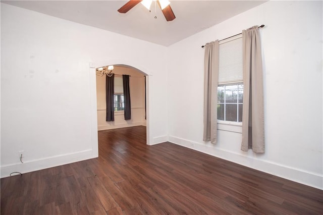 524 Camelia Ave, La Place, LA 70068 - unfurnished room featuring arched walkways, a ceiling fan, dark wood-type flooring, and a chandelier
