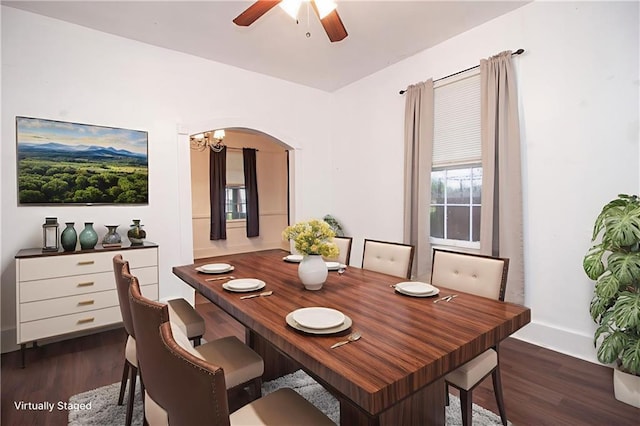 524 Camelia Ave, La Place, LA 70068 - dining room with dark wood-style floors, arched walkways, and a ceiling fan