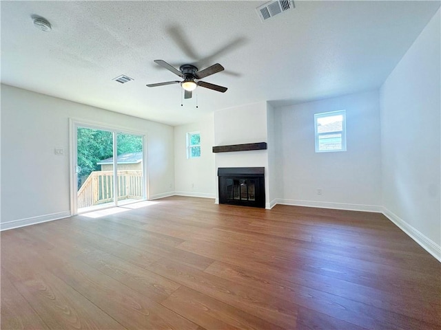 105 Kempsey Ct, Slidell, LA 70458 - unfurnished living room with a ceiling fan, wood finished floors, and a glass covered fireplace