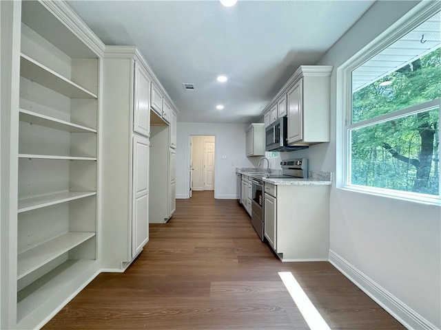 105 Kempsey Ct, Slidell, LA 70458 - kitchen featuring appliances with stainless steel finishes, recessed lighting, dark wood-style flooring, and light stone counters