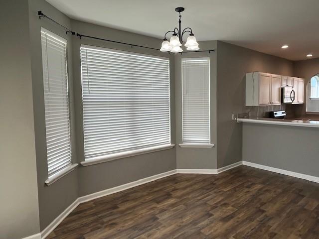 67 Carriage Ln Unit B, Destrehan, LA 70047 - kitchen with a chandelier, dark wood-type flooring, decorative light fixtures, recessed lighting, and light countertops
