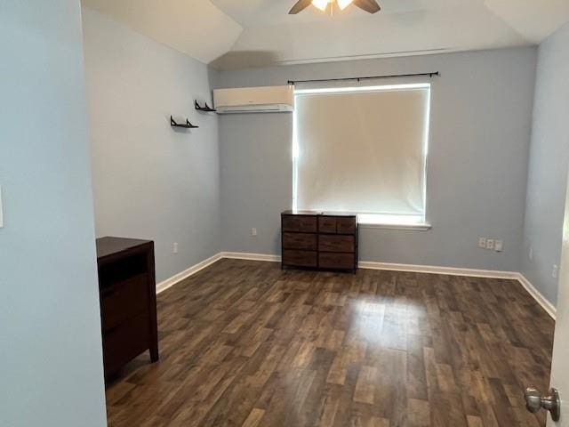 67 Carriage Ln Unit B, Destrehan, LA 70047 - unfurnished bedroom featuring a wall mounted air conditioner, dark wood-style floors, vaulted ceiling, and ceiling fan