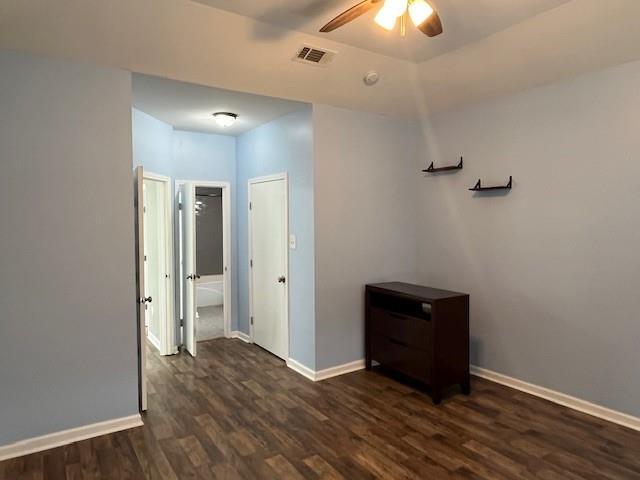 67 Carriage Ln Unit B, Destrehan, LA 70047 - empty room featuring dark wood-type flooring and a ceiling fan