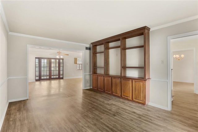 1524 Peach St, Metairie, LA 70001 - spare room featuring wood finished floors, a chandelier, ornamental molding, and ceiling fan