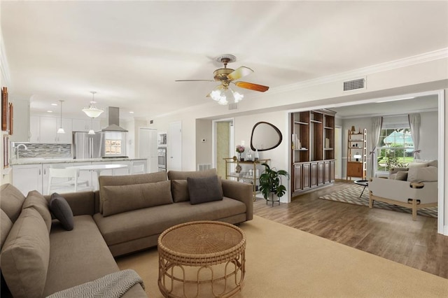 1524 Peach St, Metairie, LA 70001 - living room with crown molding, ceiling fan, and wood finished floors