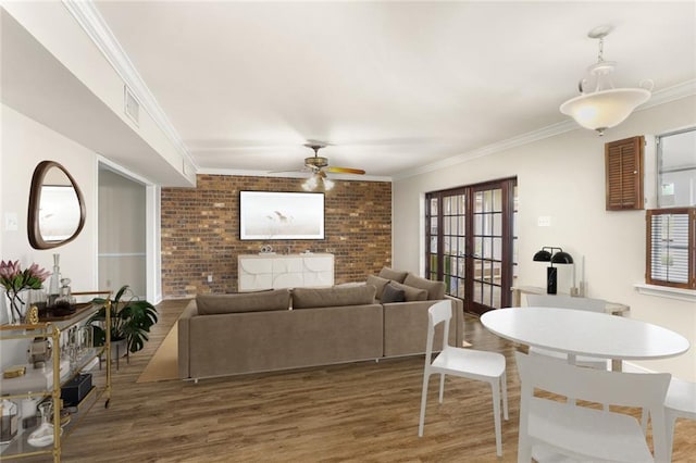 1524 Peach St, Metairie, LA 70001 - living room with ceiling fan, crown molding, wood finished floors, brick wall, and french doors