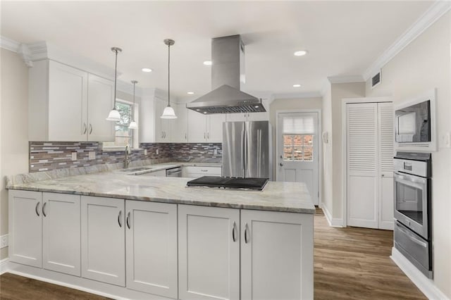 1524 Peach St, Metairie, LA 70001 - kitchen featuring island exhaust hood, appliances with stainless steel finishes, a warming drawer, healthy amount of natural light, and crown molding