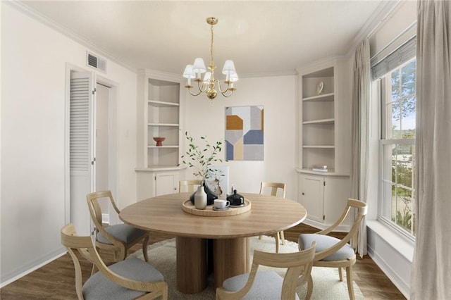 1524 Peach St, Metairie, LA 70001 - dining area with built in features, dark wood-style floors, a chandelier, and ornamental molding