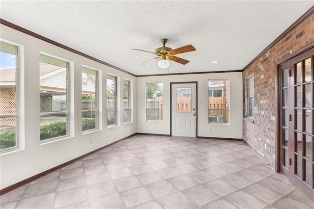 1524 Peach St, Metairie, LA 70001 - unfurnished sunroom with brick wall, ornamental molding, and a textured ceiling