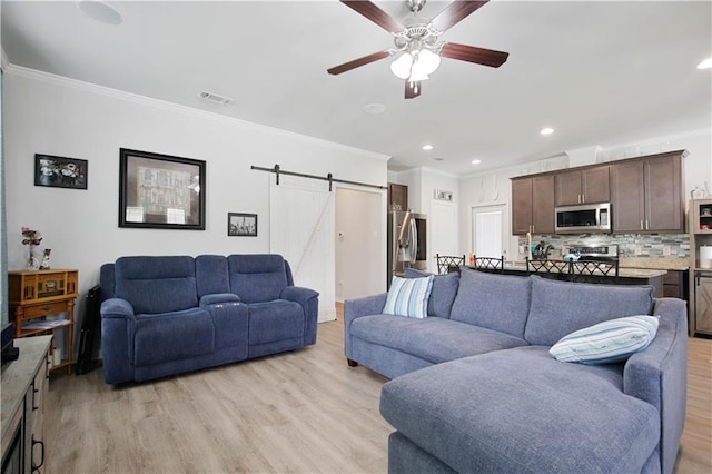 28794 Berry Todd Rd, Lacombe, LA 70445 - living room with a barn door, crown molding, light wood-style flooring, a ceiling fan, and recessed lighting