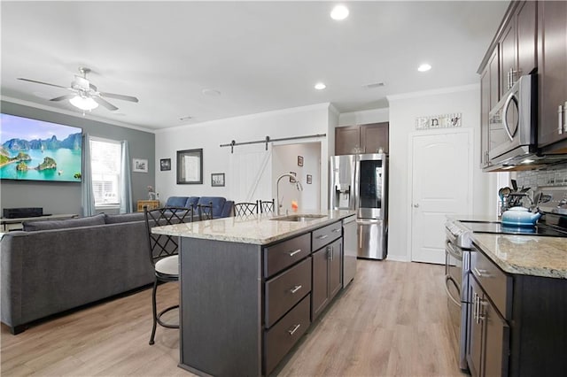 28794 Berry Todd Rd, Lacombe, LA 70445 - kitchen featuring stainless steel appliances, a breakfast bar area, ornamental molding, dark brown cabinetry, and light wood-style flooring