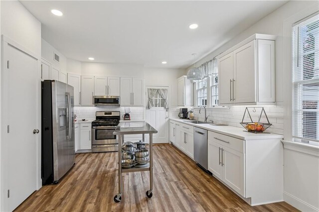 3222 Octavia St, New Orleans, LA 70125 - kitchen with stainless steel appliances, backsplash, white cabinets, light countertops, and recessed lighting