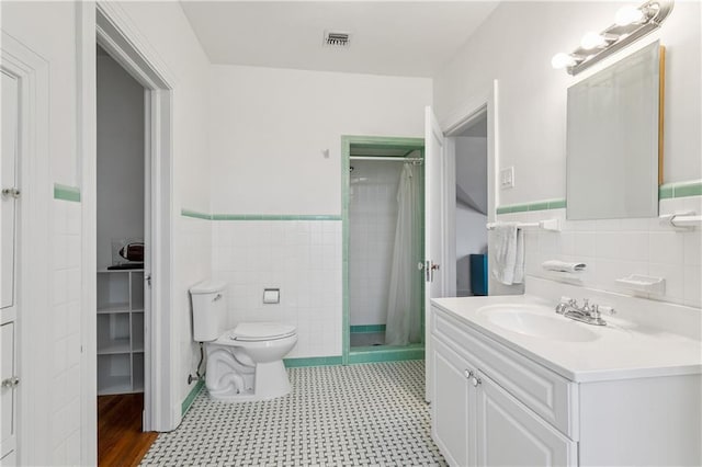 3222 Octavia St, New Orleans, LA 70125 - bathroom featuring tile walls, a shower stall, vanity, and a wainscoted wall