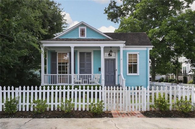 901 Henry Clay Ave, New Orleans, LA 70118 - view of front of house with covered porch and a fenced front yard