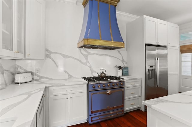 901 Henry Clay Ave, New Orleans, LA 70118 - kitchen featuring gas stove, stainless steel fridge with ice dispenser, custom exhaust hood, light stone counters, and white cabinets