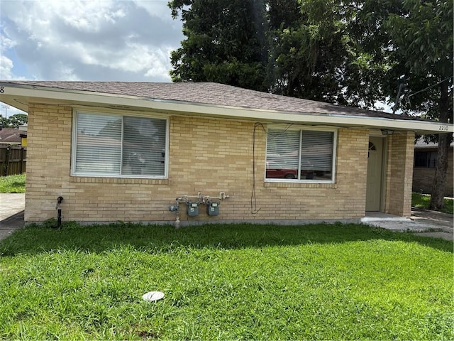 220810 Kraft Pl, New Orleans, LA 70114 - view of front of house featuring a front yard and brick siding