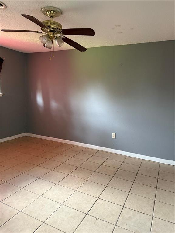 220810 Kraft Pl, New Orleans, LA 70114 - unfurnished room featuring ceiling fan, light tile patterned floors, and a textured ceiling