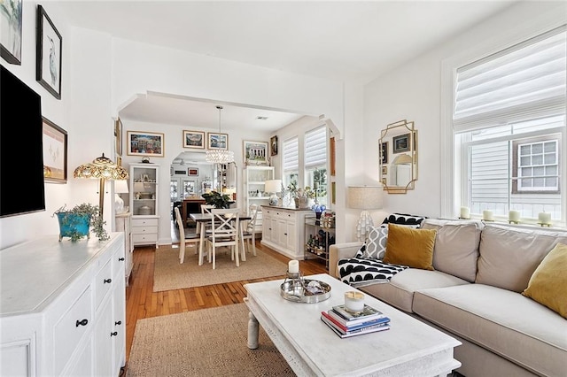 3116 Beaulieu St, Metairie, LA 70001 - living area with arched walkways and light wood-type flooring