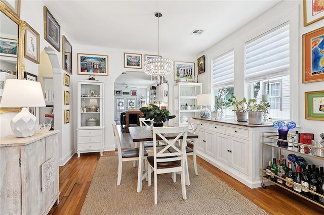 3116 Beaulieu St, Metairie, LA 70001 - dining room featuring arched walkways, a chandelier, and light wood-style floors