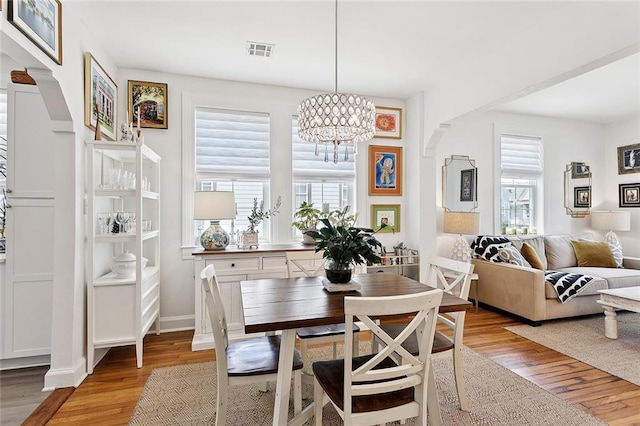3116 Beaulieu St, Metairie, LA 70001 - dining area featuring healthy amount of natural light, a chandelier, and light wood-style flooring