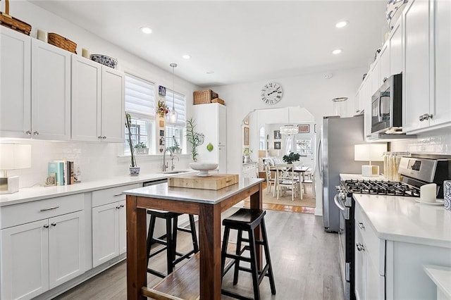 3116 Beaulieu St, Metairie, LA 70001 - kitchen featuring stainless steel appliances, backsplash, recessed lighting, light countertops, and light wood-style flooring