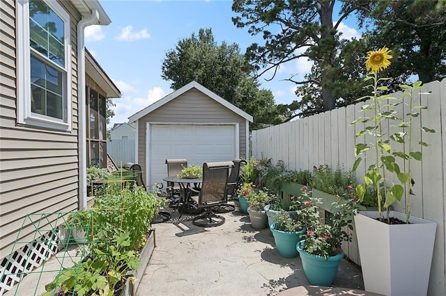 3116 Beaulieu St, Metairie, LA 70001 - view of patio featuring an outdoor structure, a detached garage, and outdoor dining space