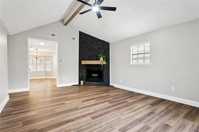 2306 Bluebird St, Slidell, LA 70460 - unfurnished living room with ceiling fan, wood finished floors, a fireplace, and a chandelier