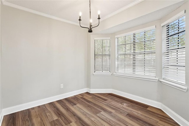 2306 Bluebird St, Slidell, LA 70460 - empty room featuring a chandelier, ornamental molding, and dark wood-style flooring