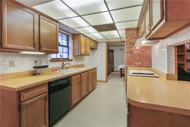 2820 Metairie Ct, Metairie, LA 70002 - kitchen featuring black dishwasher, wallpapered walls, light flooring, under cabinet range hood, and light countertops
