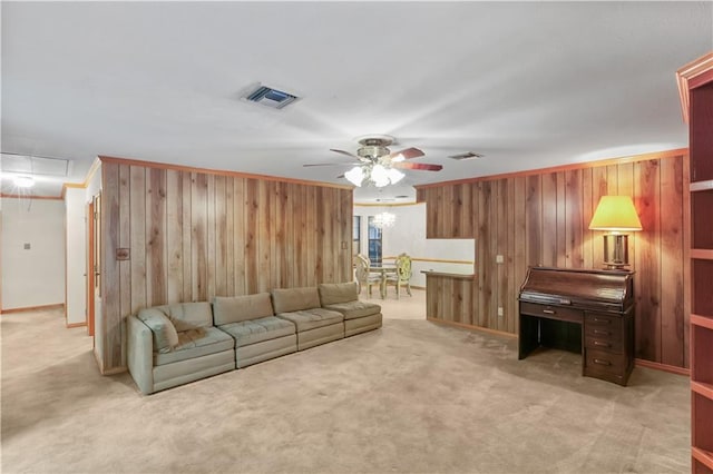 2820 Metairie Ct, Metairie, LA 70002 - living room featuring wood walls, attic access, a ceiling fan, and light carpet